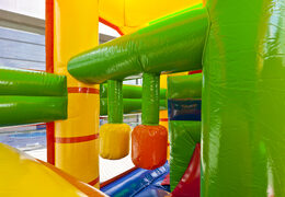 Multiplay lion bouncer with a slide, pillars on the jumping surface and striking 3D objects for children. Order inflatable bouncers online at JB Inflatables America