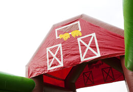 Order a 17 meter wide inflatable obstacle course in a farm theme for children. Buy inflatable obstacle courses online now at JB Inflatables America