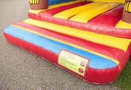 Standard bounce houses in striking colors with a large 3D object of a monkey on top for sale for children. Buy bounce houses online at JB Inflatables America