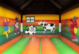 Order a standard bounce houses for children in striking colors with a large 3D object of a cow on top. Bounce houses for sale online at JB Inflatables America