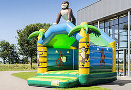 Buy a standard jungle bounce houses for children in striking colors with a large 3D object in the shape of a gorilla on the top. Order bounce houses online at JB Inflatables America