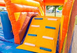 Inflatable covered bouncer in a pirate theme with a slide on the jumping surface, climbing tower and fun obstacles for kids. Buy bouncers online at JB Inflatables America 