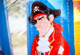 Order a large Indoor pirate bouncer with a slide on the jumping surface, climbing tower and fun obstacles in pirate themed with prints for kids. Buy bouncers online at JB Inflatables America 