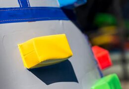 Inflatable covered bouncer in a castle theme with a slide on the jumping surface, climbing tower and fun obstacles for kids. Buy bouncers online at JB Inflatables America 