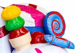 Indoor multiplay candyland bounce house in a unique design with two entrances, a slide in the middle and 3D objects for kids. Buy bounce houses online at JB Inflatables America 