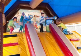 Buy shooting combo pirate bounce house with shooting game and slide for kids. Order bounce houses online at JB Inflatables America