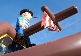 Buy shooting combo pirate bounce house with cover, shooting game and slide for kids. Order bounce houses online at JB Inflatables America