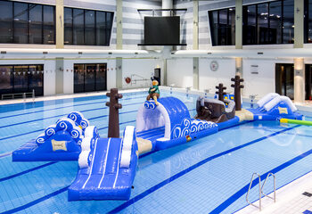 Order double inflatable 16 meter long pirate run swimming pool obstacle course in a unique design with funny 3D objects and no less than 2 slides for kids. Buy inflatable obstacle courses online now at JB Inflatables America