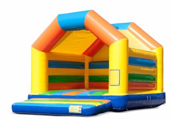 Buy a large indoor bounce house in the colors yellow, orange, green and blue for children. Order bounce houses online at JB Inflatables America