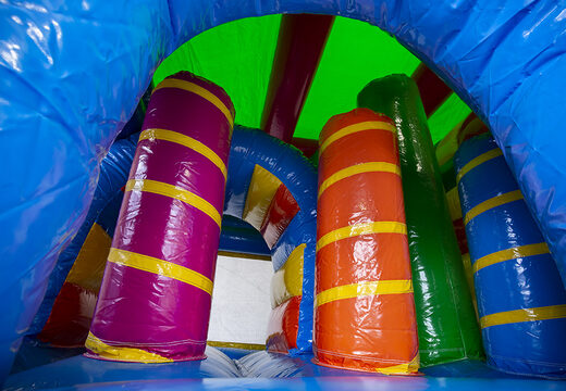 Multiplay unicorn bounce house with a slide, pillars on the jumping surface and striking 3D objects for children. Order inflatable bounce houses online at JB Inflatables America