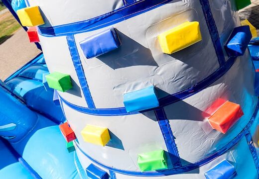 Order a large Indoor castle bouncer with a slide on the jumping surface, climbing tower and fun obstacles with castle themed prints for children. Buy bouncers online at JB Inflatables America 