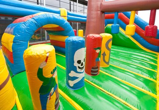 Order a pirate boat bounce house in a unique design with two entrances, a slide in the middle and 3D objects for kids. Buy bounce houses online at JB Inflatables America 