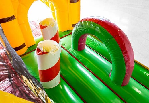 Order Jungleworld bounce house in a unique design with two entrances, a slide in the middle and 3D objects for kids. Buy bounce houses online at JB Inflatables America 