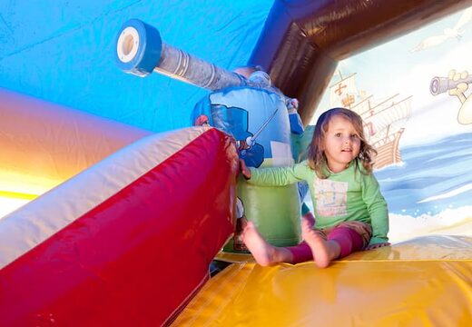 Order shooting combo pirate bouncy castle covered, with cannon game and slide for kids. Buy bouncy castles online at JB Inflatables America